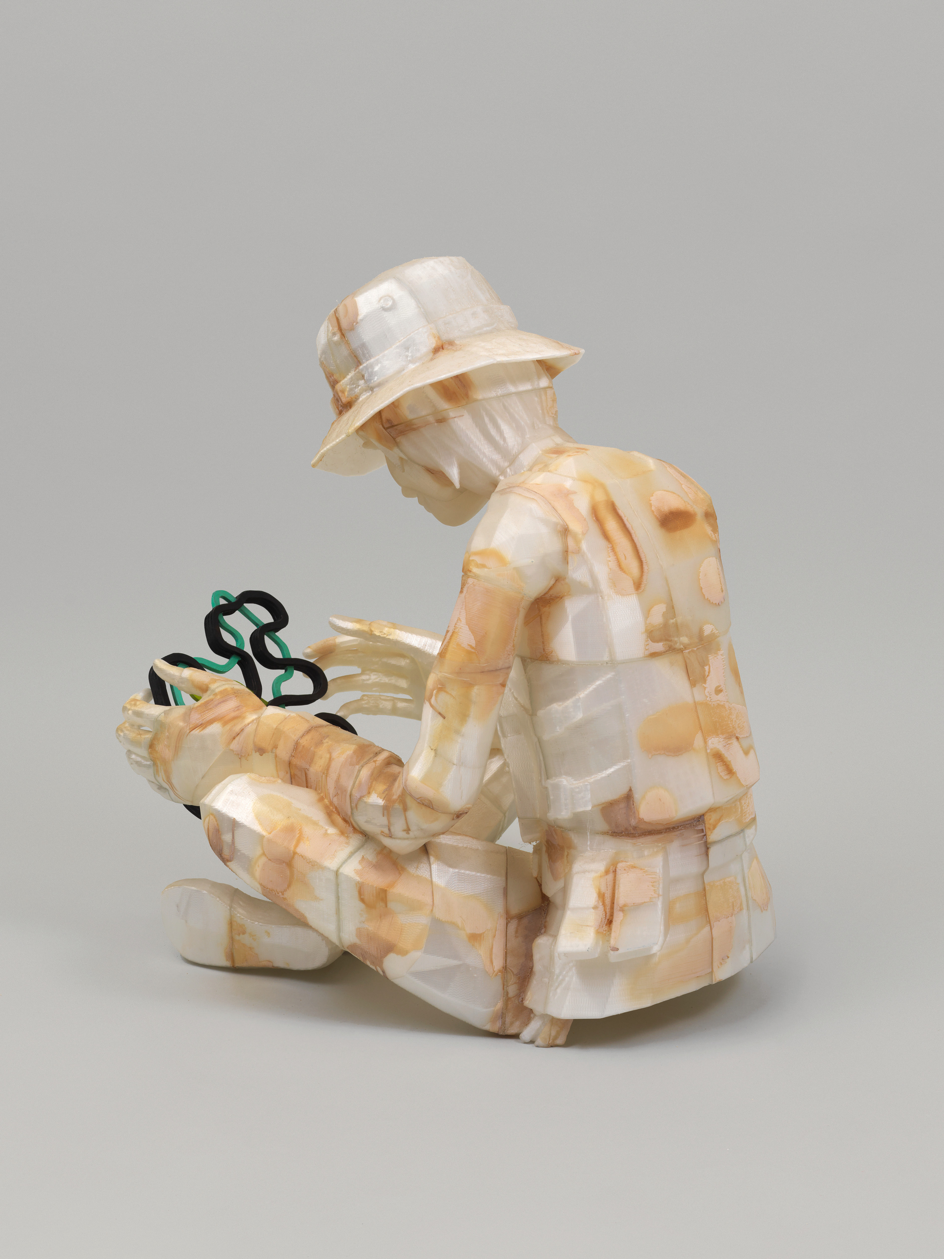 Child Soldier Examining Fun Shape — image 3 of 3